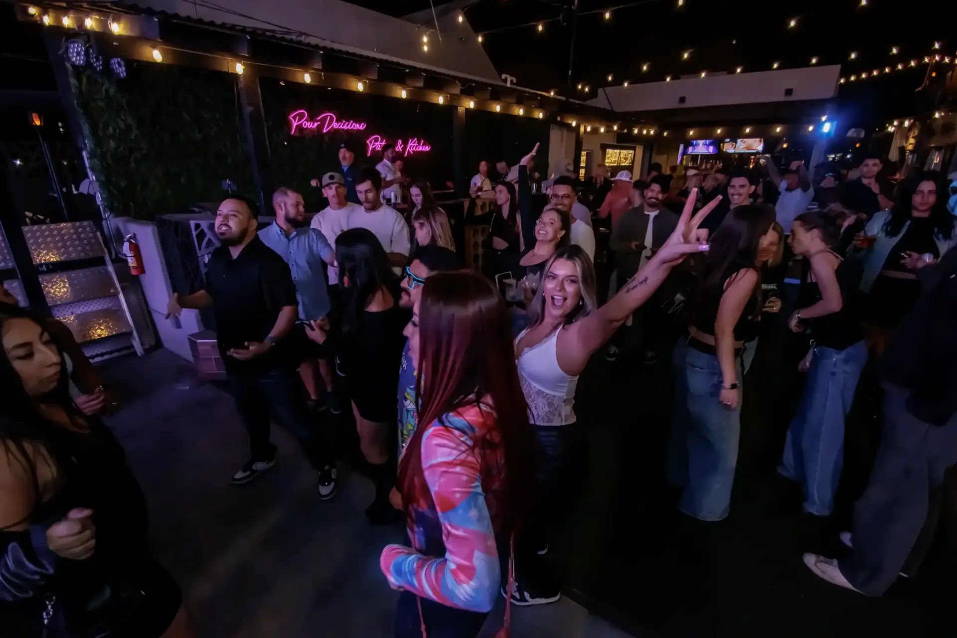 A lively evening crowd inside Poor Decisions Patio and Kitchen